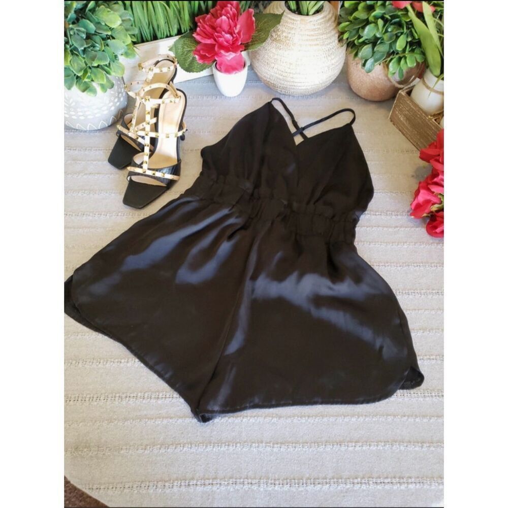 woman’s black polyester romper.